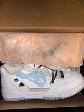 White Sneaker with Light Blue Flame Graphic
